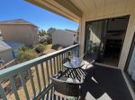 Private back balcony overlooking large green space.